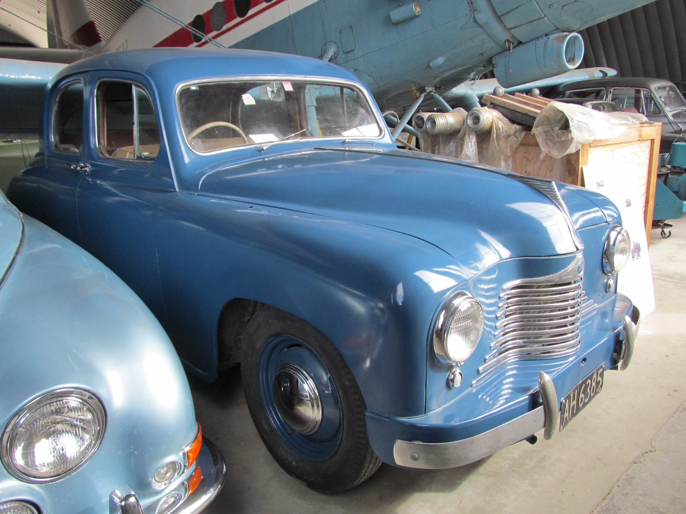 this blue car is parked in a garage