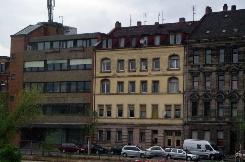 two buildings next to each other with cars in front