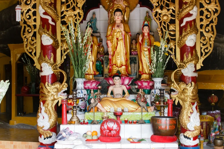 many gold statues are on display at a shrine