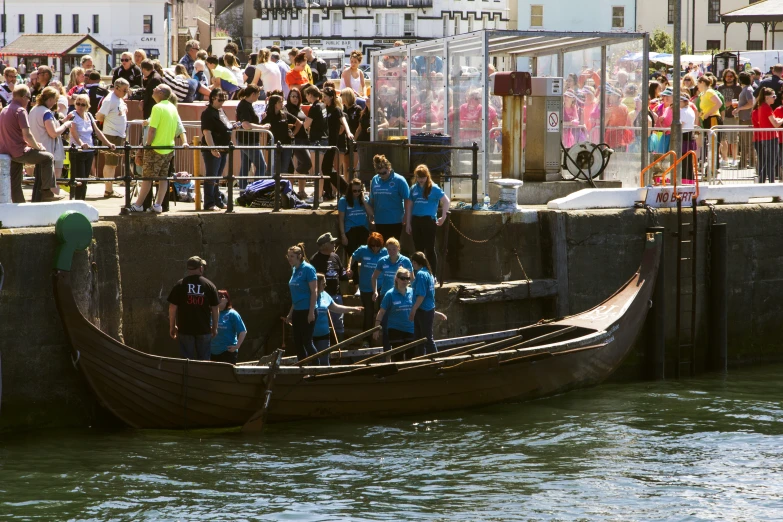 a large group of people on a boat in the water