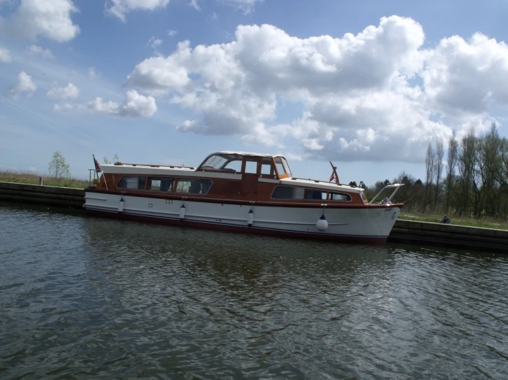 a brown and white boat on the water