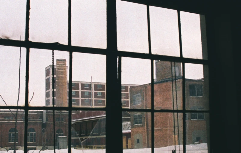 a building with buildings and trees outside from through an open window