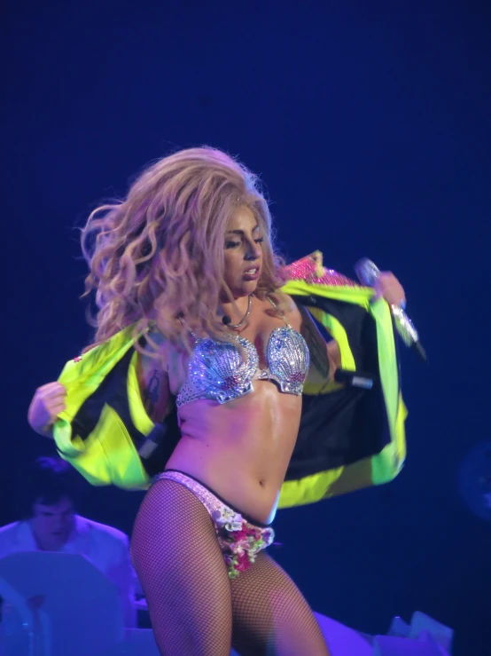 a young female in fishnets and panties with a jacket