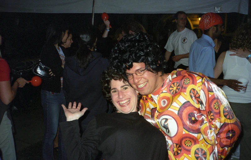 two people dressed in costume standing together at night