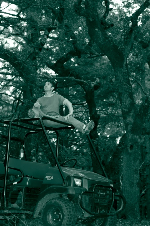 a man is riding an atv in the woods