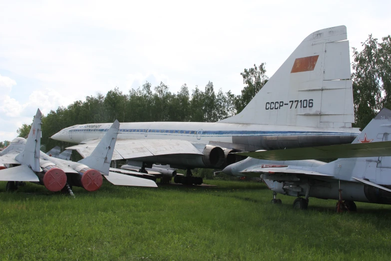 several planes are parked side by side in the grass