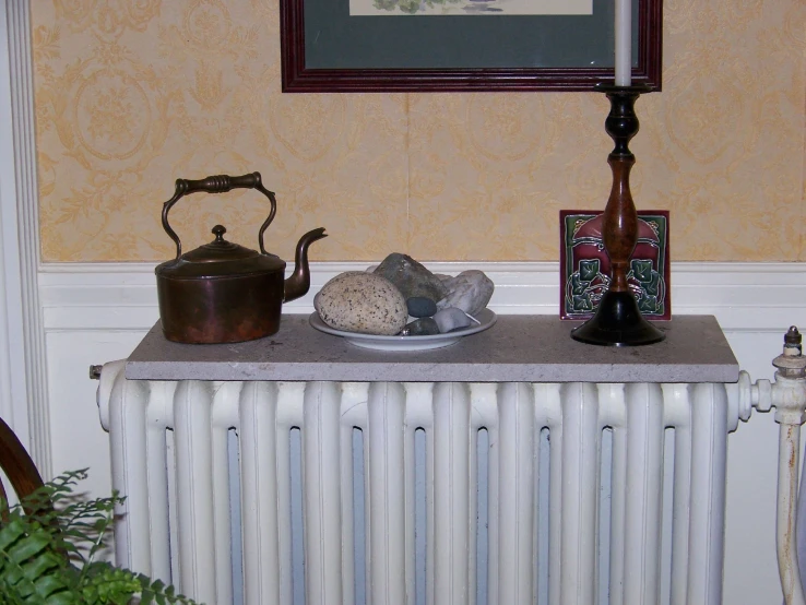 a table with a teapot and various knick - knacks