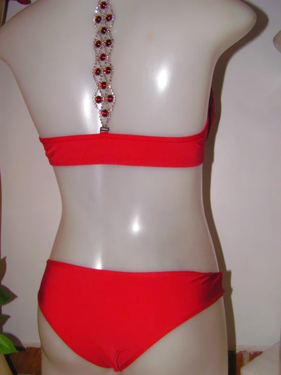 red swimsuit with beaded trim on display