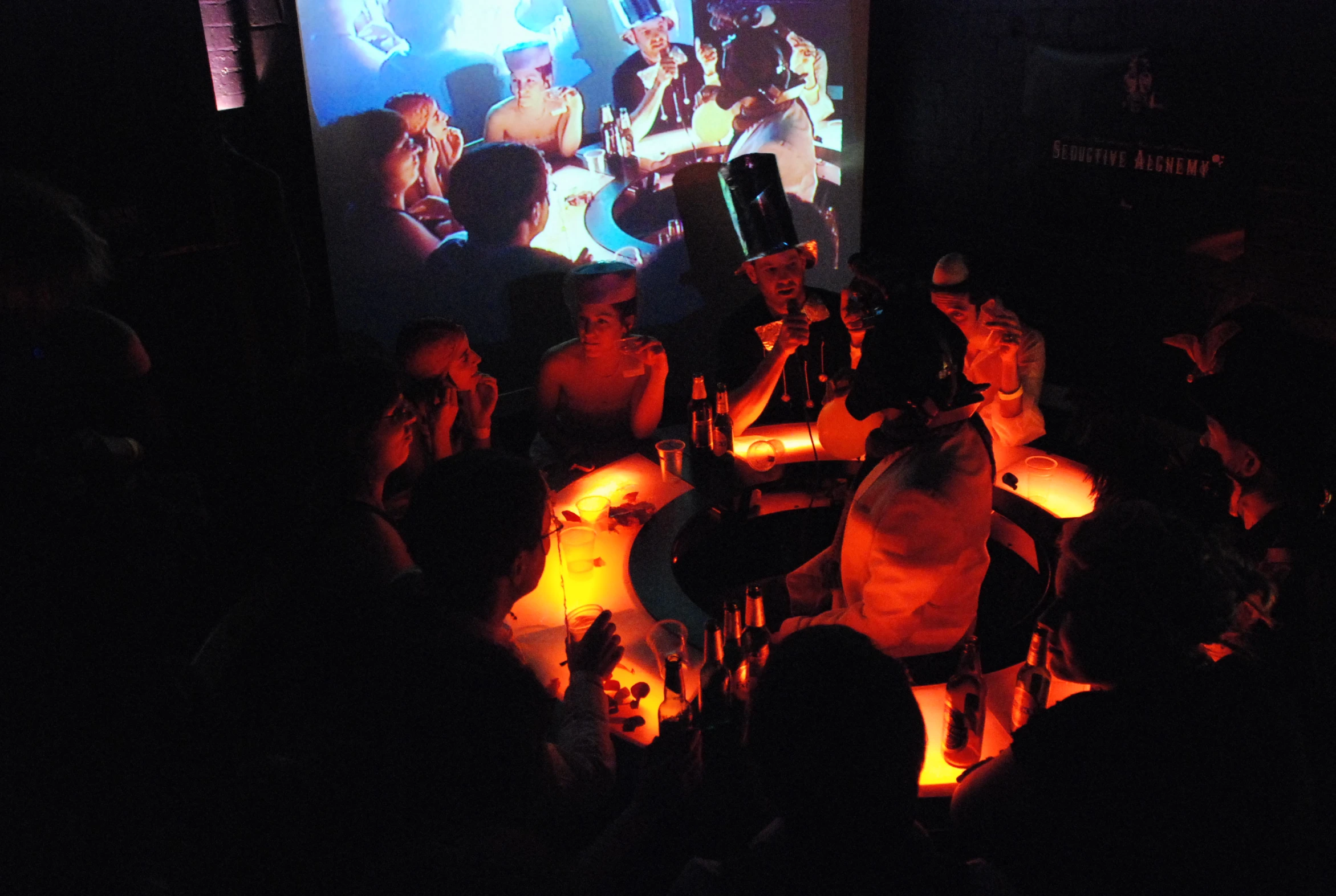 a group of people watching a movie in a dark room