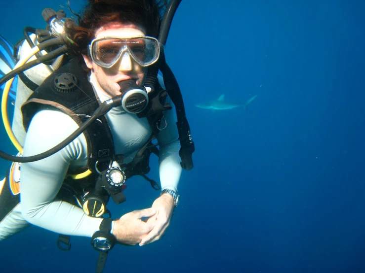 a man in a scuba suit and glasses on in the water