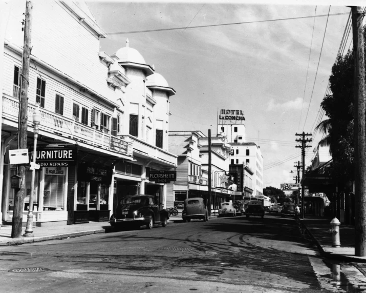 an old black and white po of buildings along a street