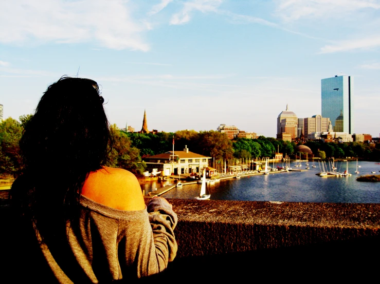 a woman standing in front of a large lake