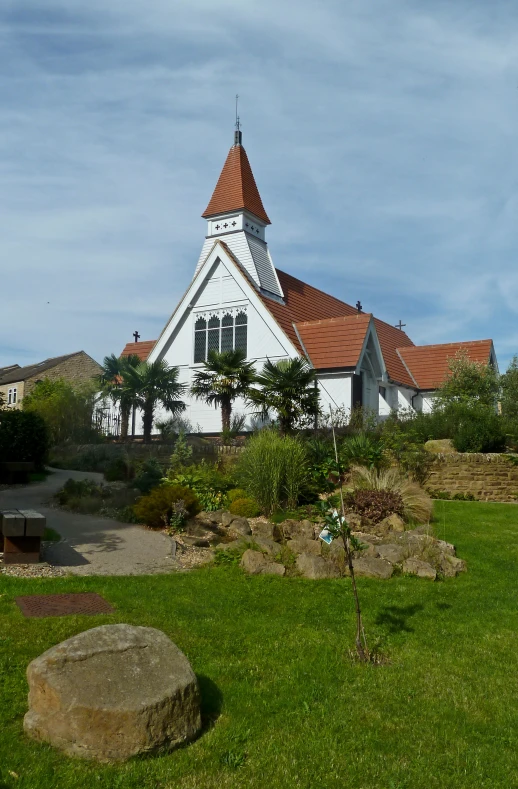 an old church with the flag waving down