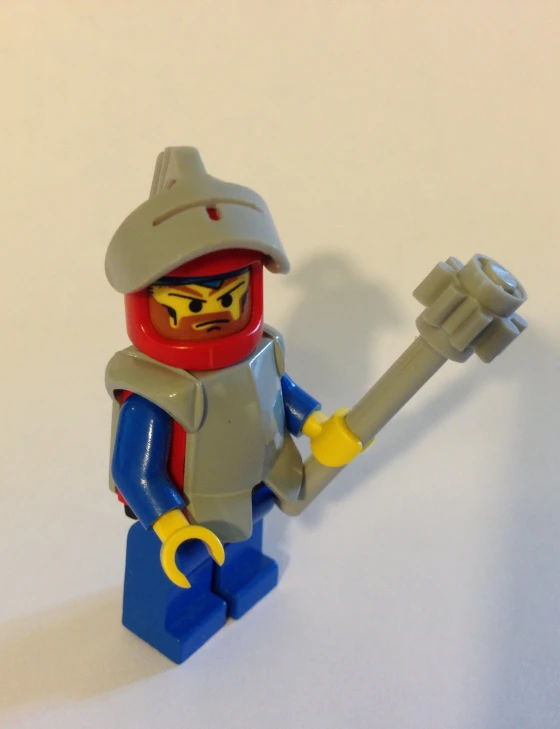 a lego character holding a giant brick gun