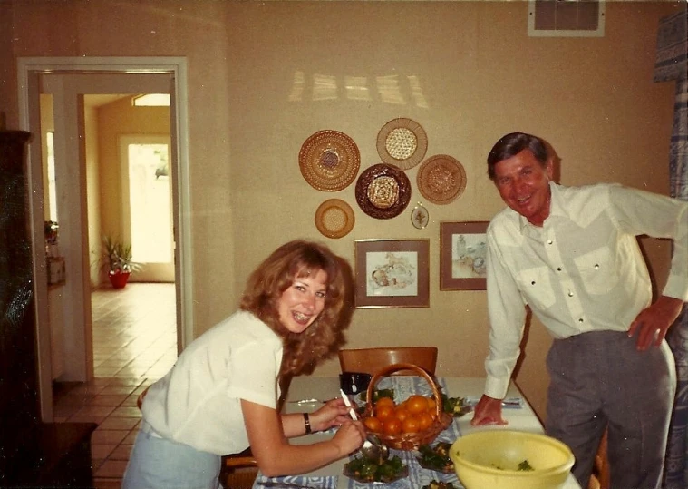 a man and woman posing in the kitchen