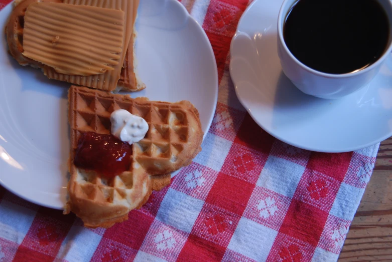 waffles and syrup are on a plate on the table
