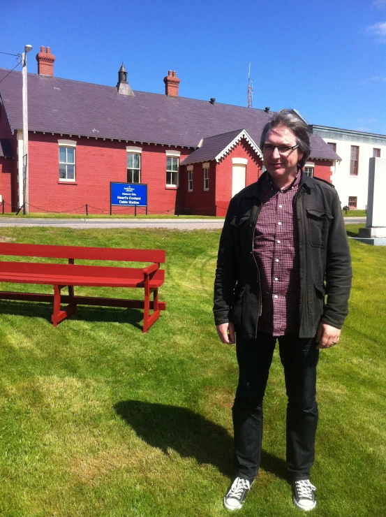 a person standing in front of a red bench