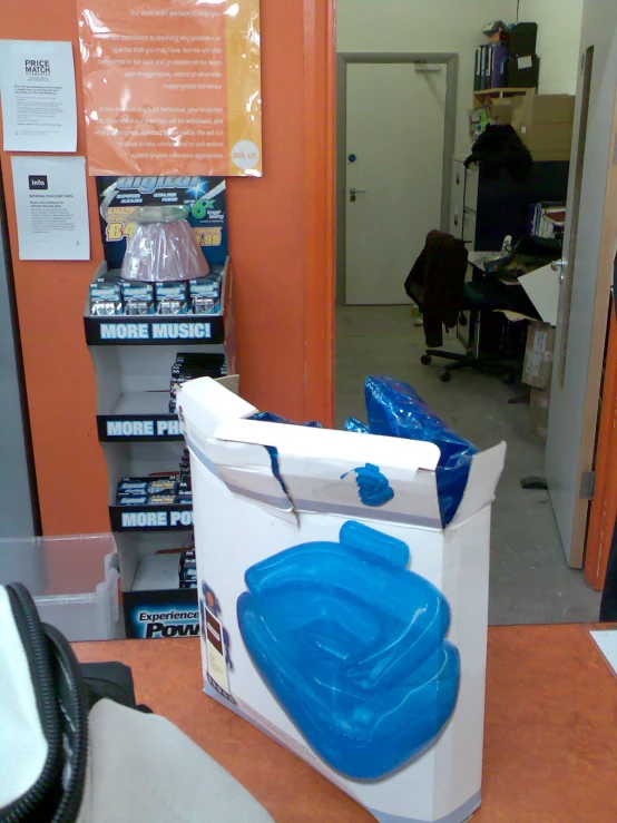 a box with blue and white handles sits on an orange table
