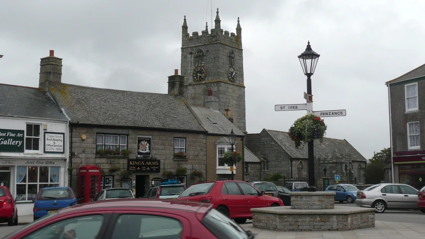 a street corner with a church and two traffic signs