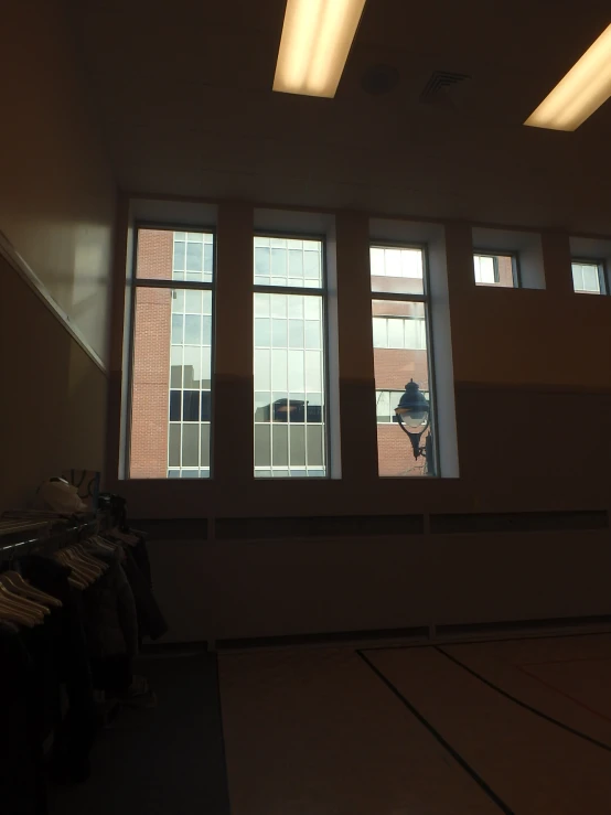 this large empty room has a lamp and windows