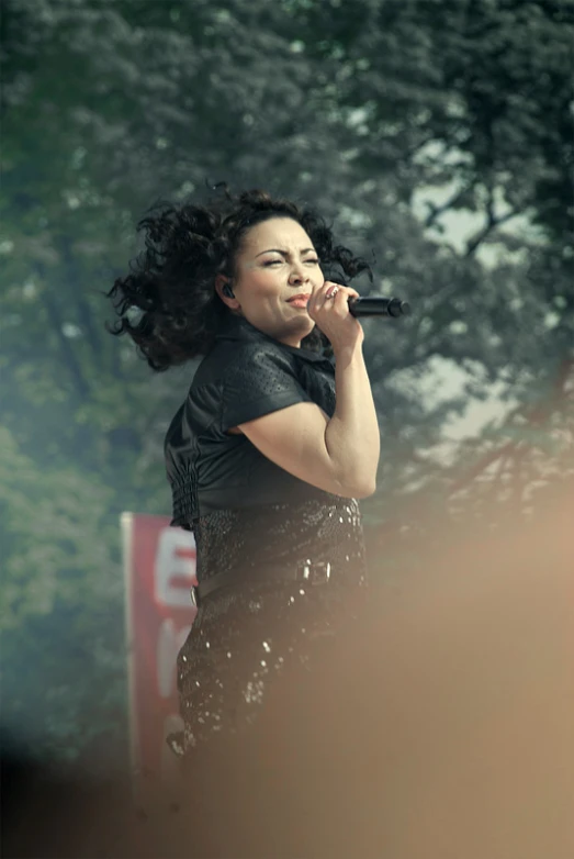 a woman that is standing up with a microphone