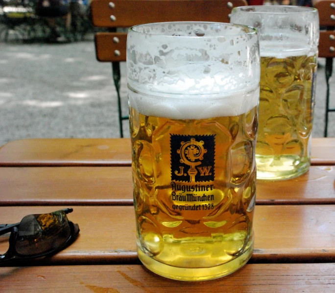 two glasses of beer are sitting on a table