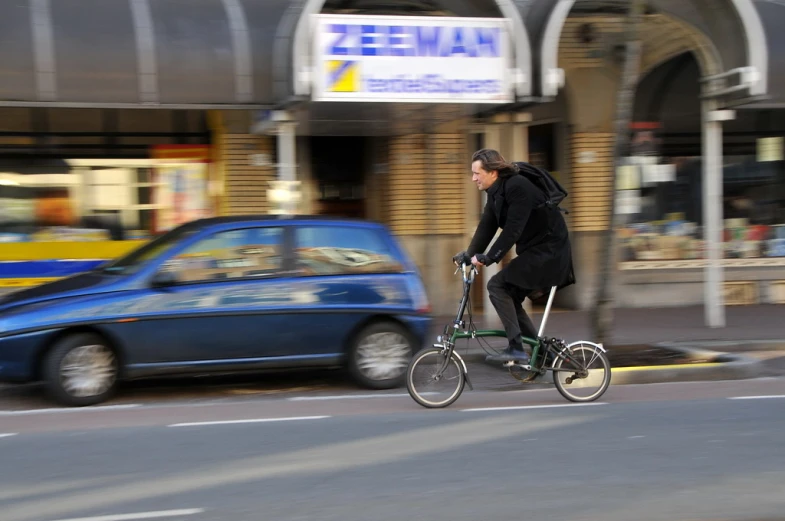 a man on a bike rides down the road