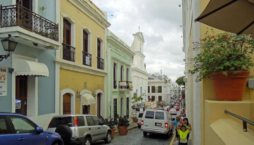 street with cars, a couple people and buildings