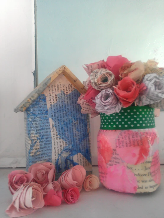 pink roses and a house made from a piece of paper