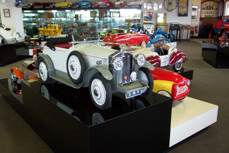 a museum of different old model cars and trucks