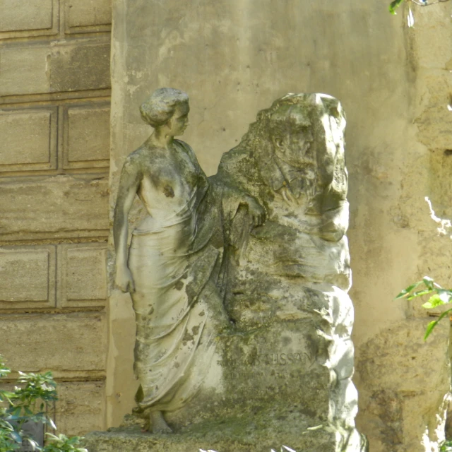 an ancient statue sitting in front of a building