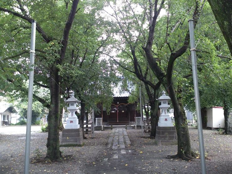 a row of small pagodas next to trees