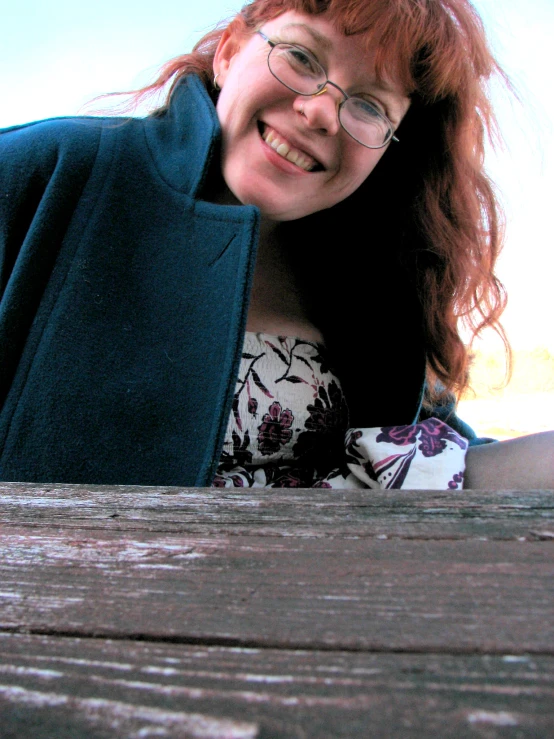 a close up po of a woman leaning against a board