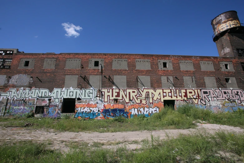 graffiti on the side of an old factory building