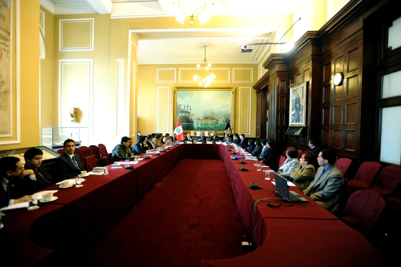 several people are sitting around a long table