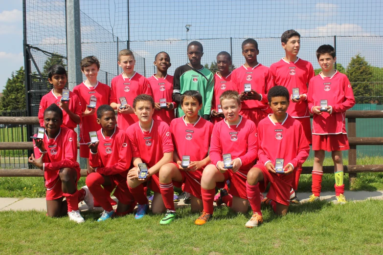 a group of children standing on the soccer field