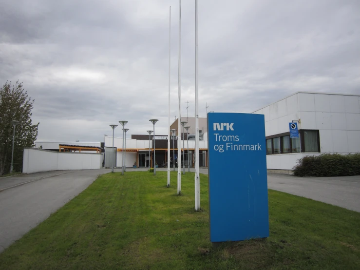 a large blue sign sitting outside of a building