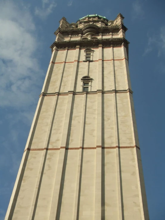 a tall building has a clock on the front