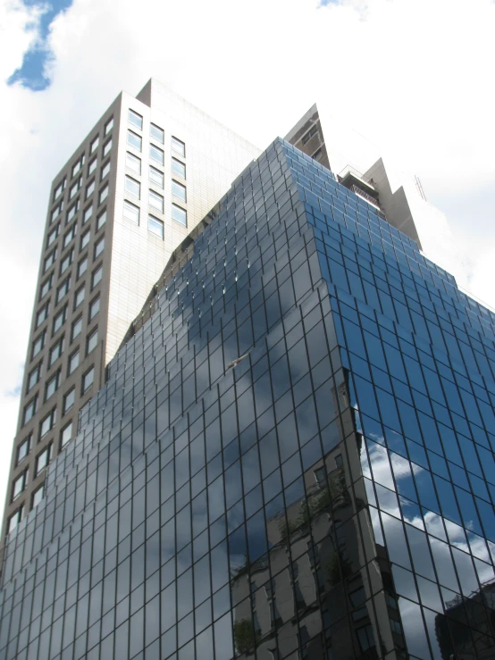 a large building reflected in another tall building