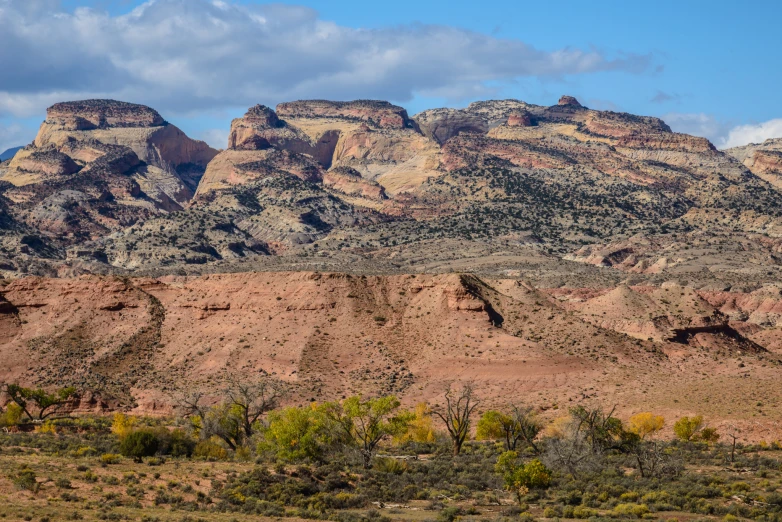 some mountain tops near some bushes and a small hill