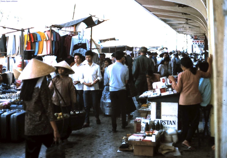 a crowd of people standing around a store