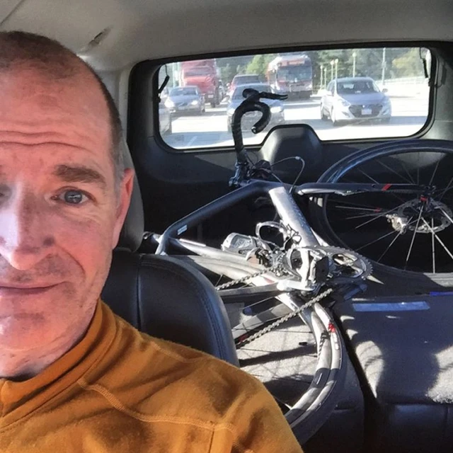 a man who is smiling while in his car