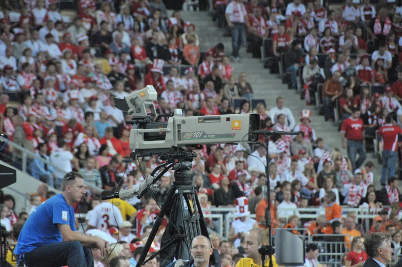 a camera and some people in the stands