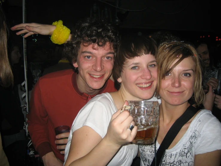 two young people posing for the camera at a night club