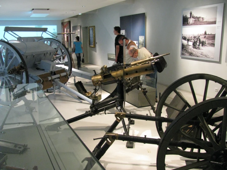 two men look at a model of a cannon