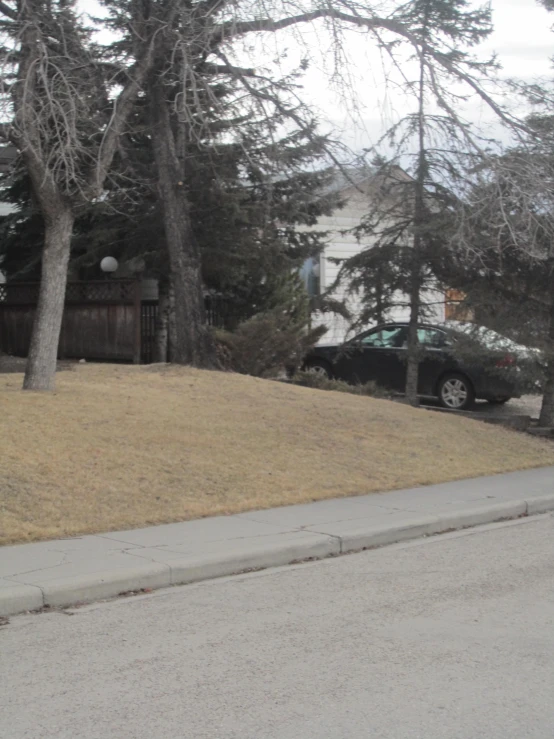 a green truck parked in front of a house