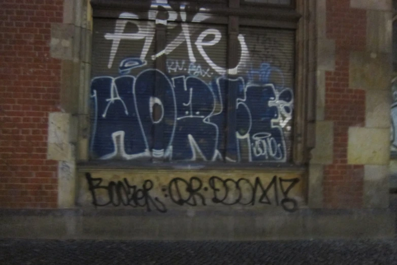 a graffiti covered window in an alley way