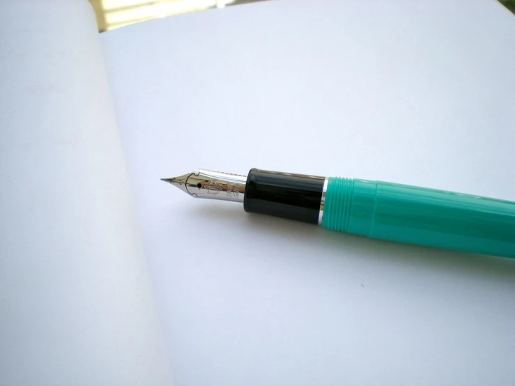 a pen sits on top of a paper while it lays down