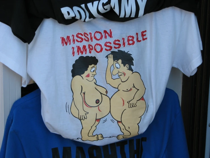 a white tshirt that says mission impossible inside two fat, black and red shirts with cartoon images on them