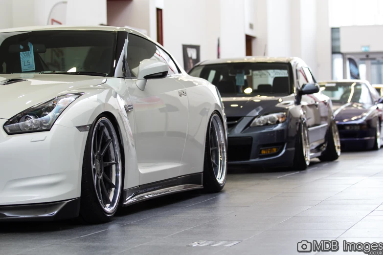 a row of nissan cars in a showroom